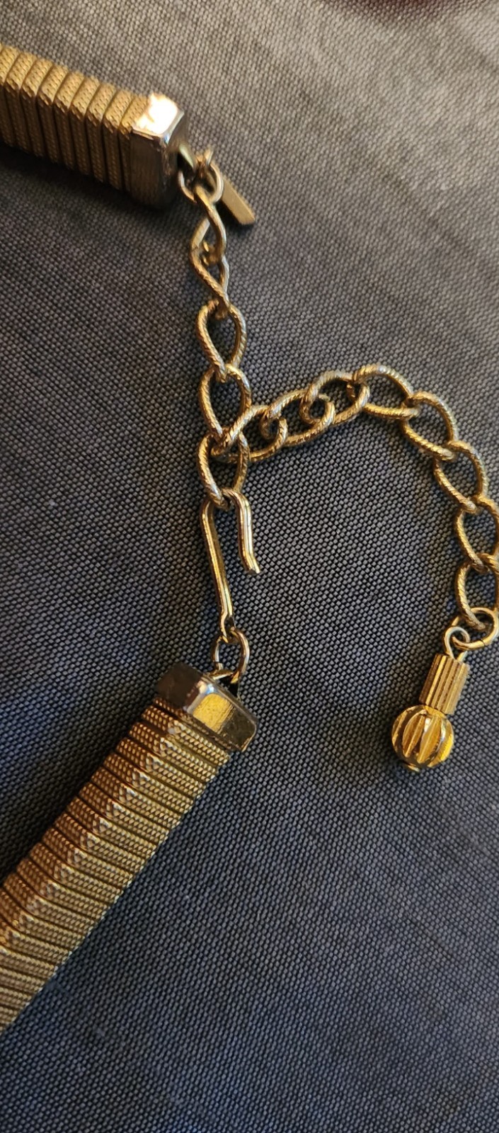 Goldtone chocker necklace, stretchy with triangular slide pendant