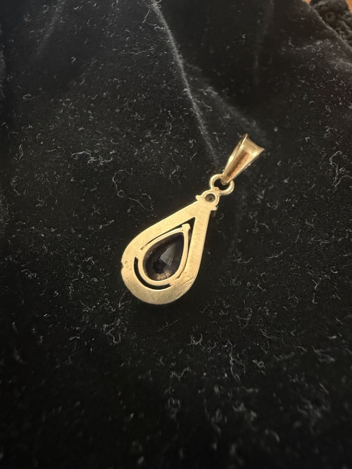 18k yellow gold teardrop pendant with natural sapphire and diamond.