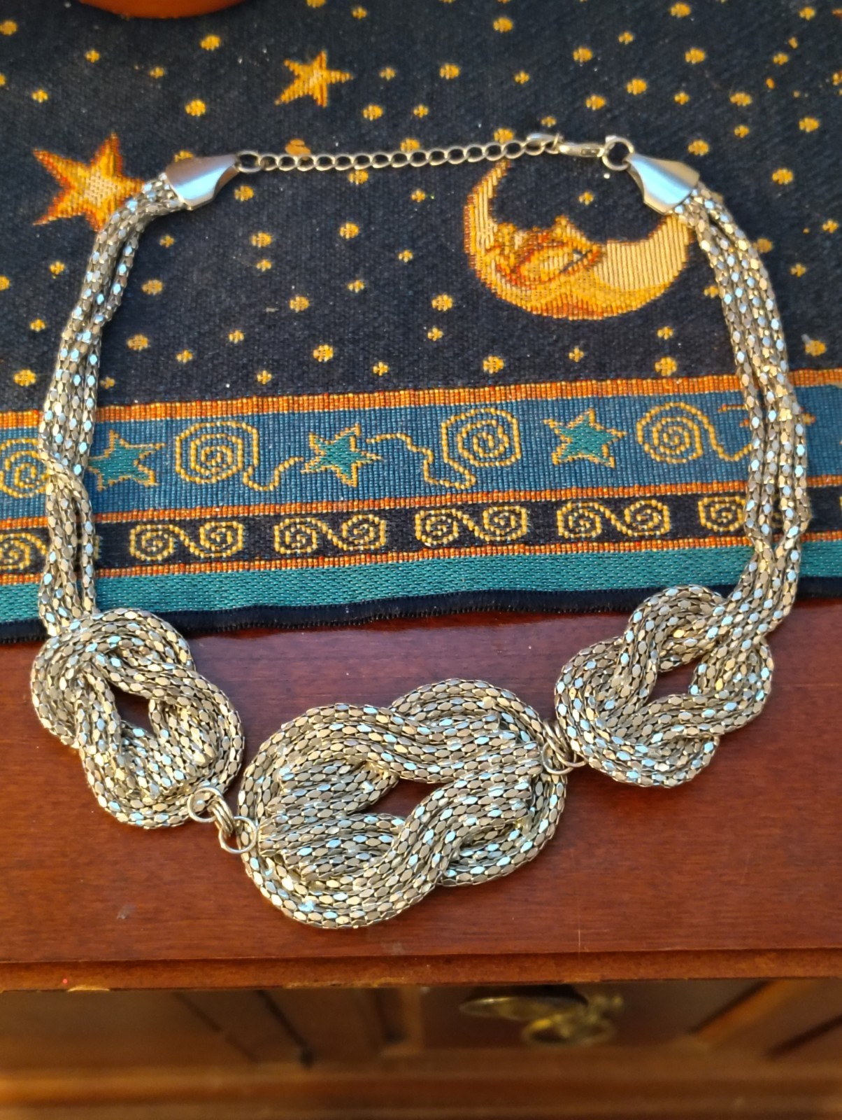 silver-tone chunky braided rope-style statement necklace three knotted details.