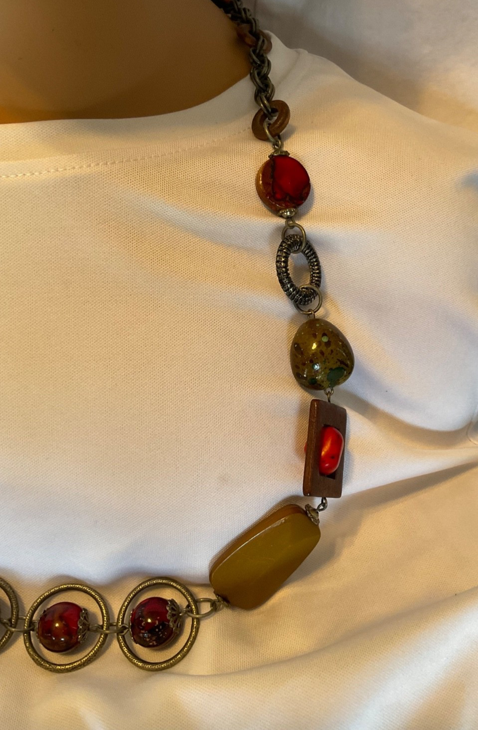 chicos 37” necklace featuring red, green and brown beads with geometric rings