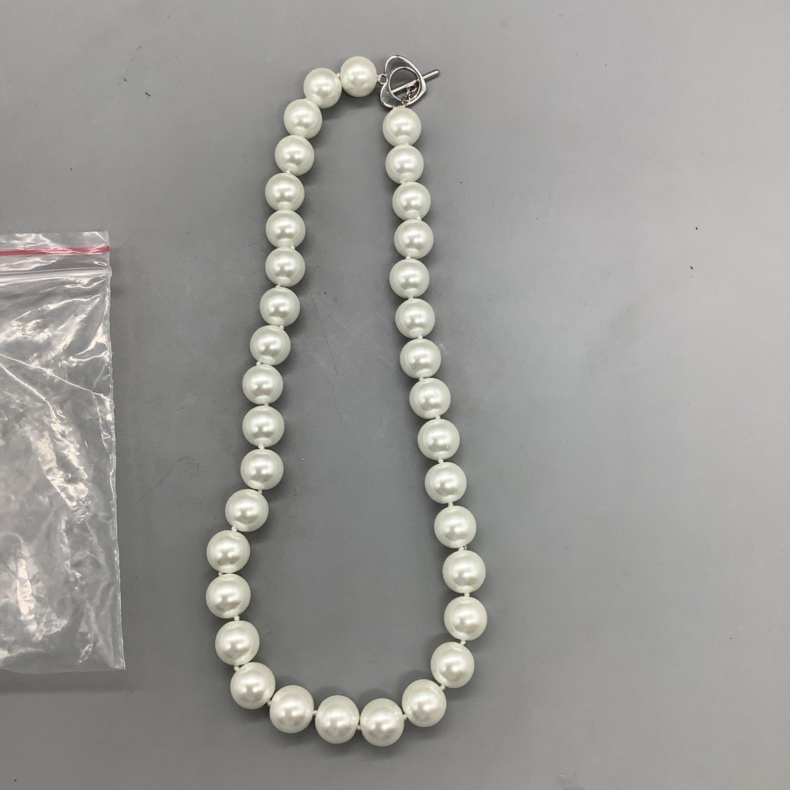 Medium Sized Pearls/Pearl Necklace w/ Heart Shaped Clasp That Connects w/ Bar