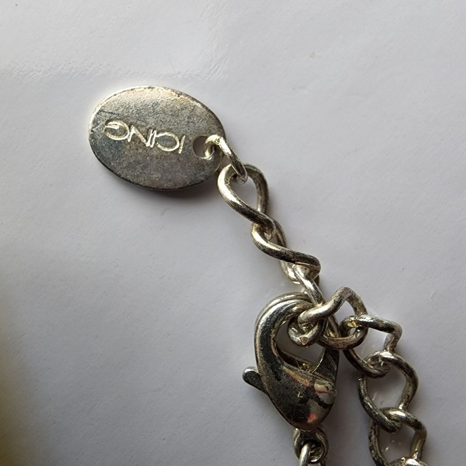 Silver tone necklace with prongs set white rhinestones round and square in shape