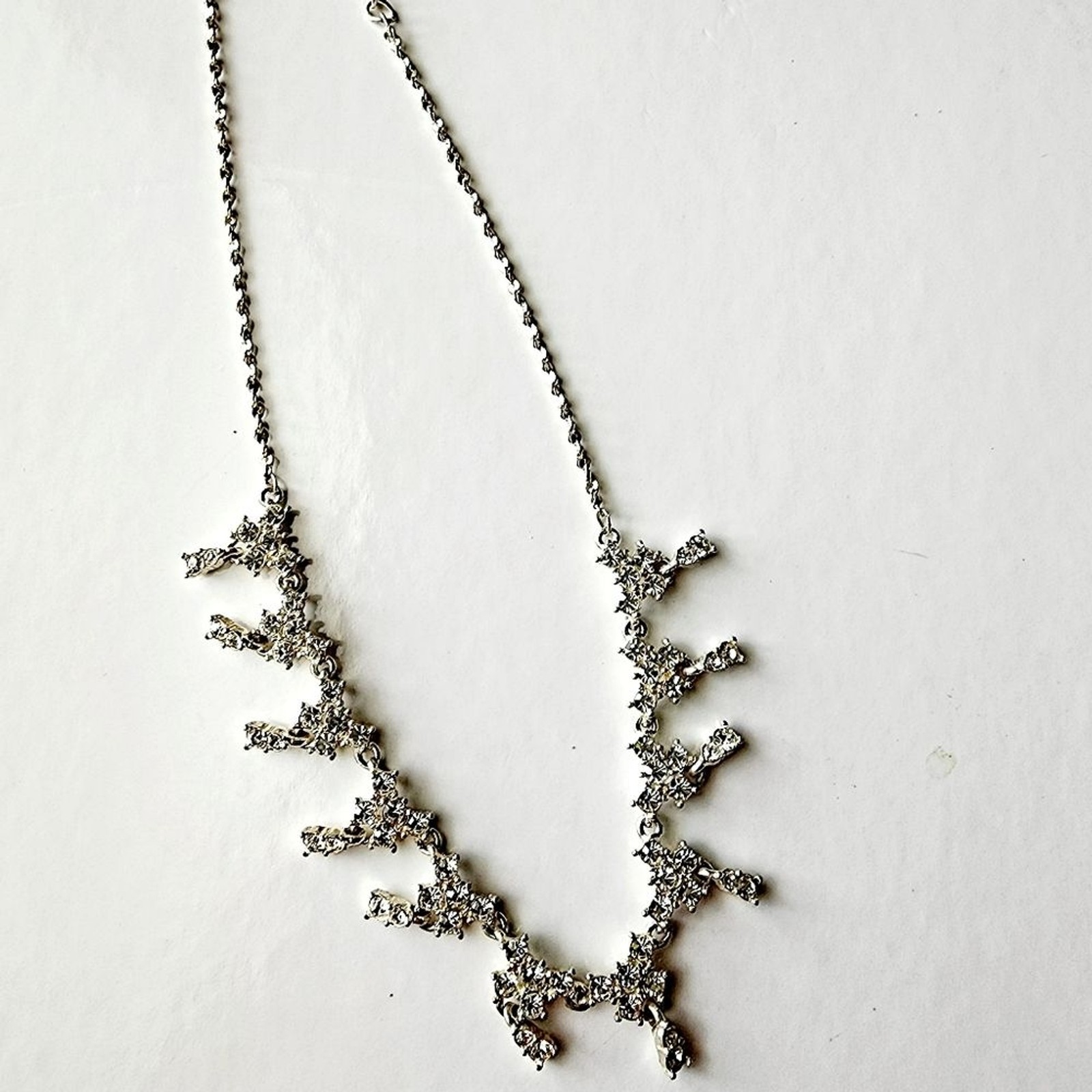 Silver tone necklace with prongs set white rhinestones round and square in shape