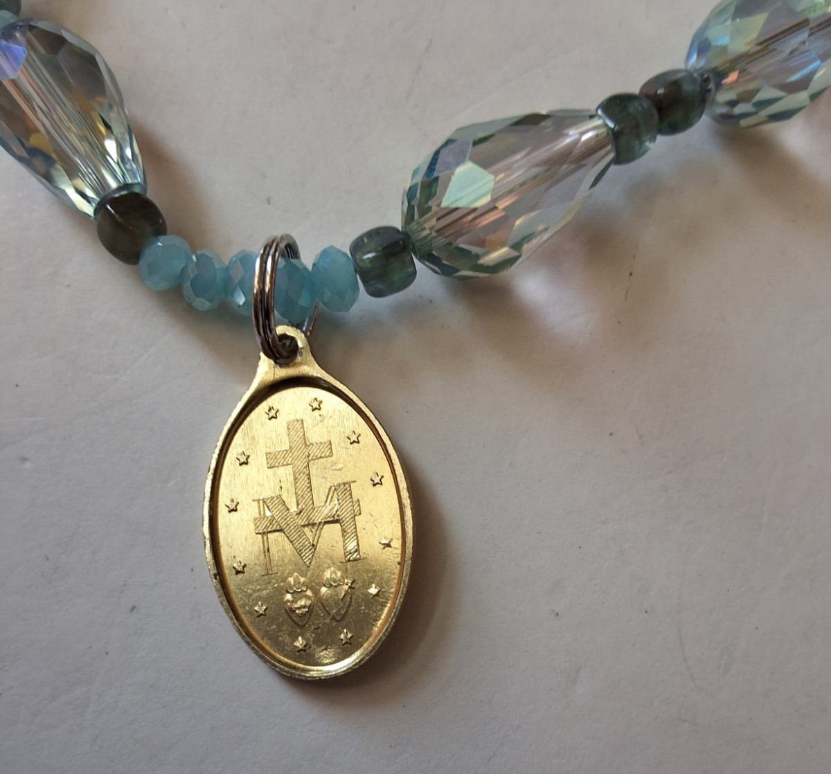 Iridescent Beaded Necklace With Gold Tone Miraculous Medal And Brooch