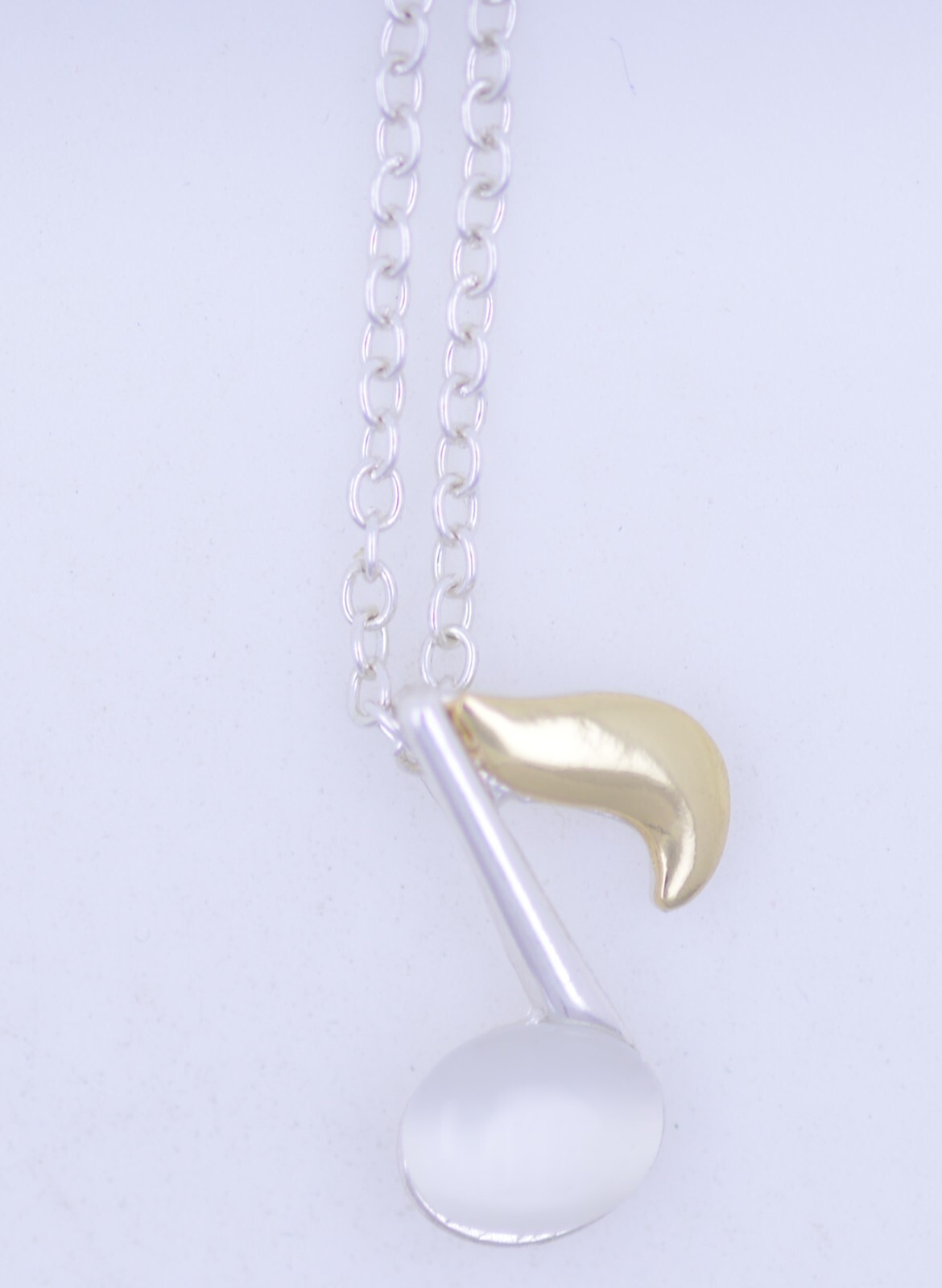 Cute white and gold coloured musical note necklace