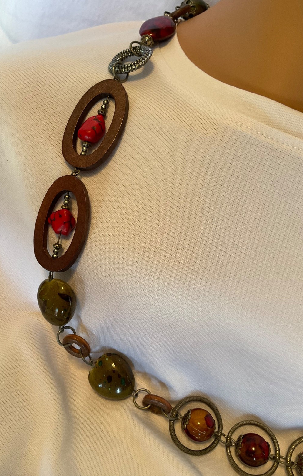 chicos 37” necklace featuring red, green and brown beads with geometric rings