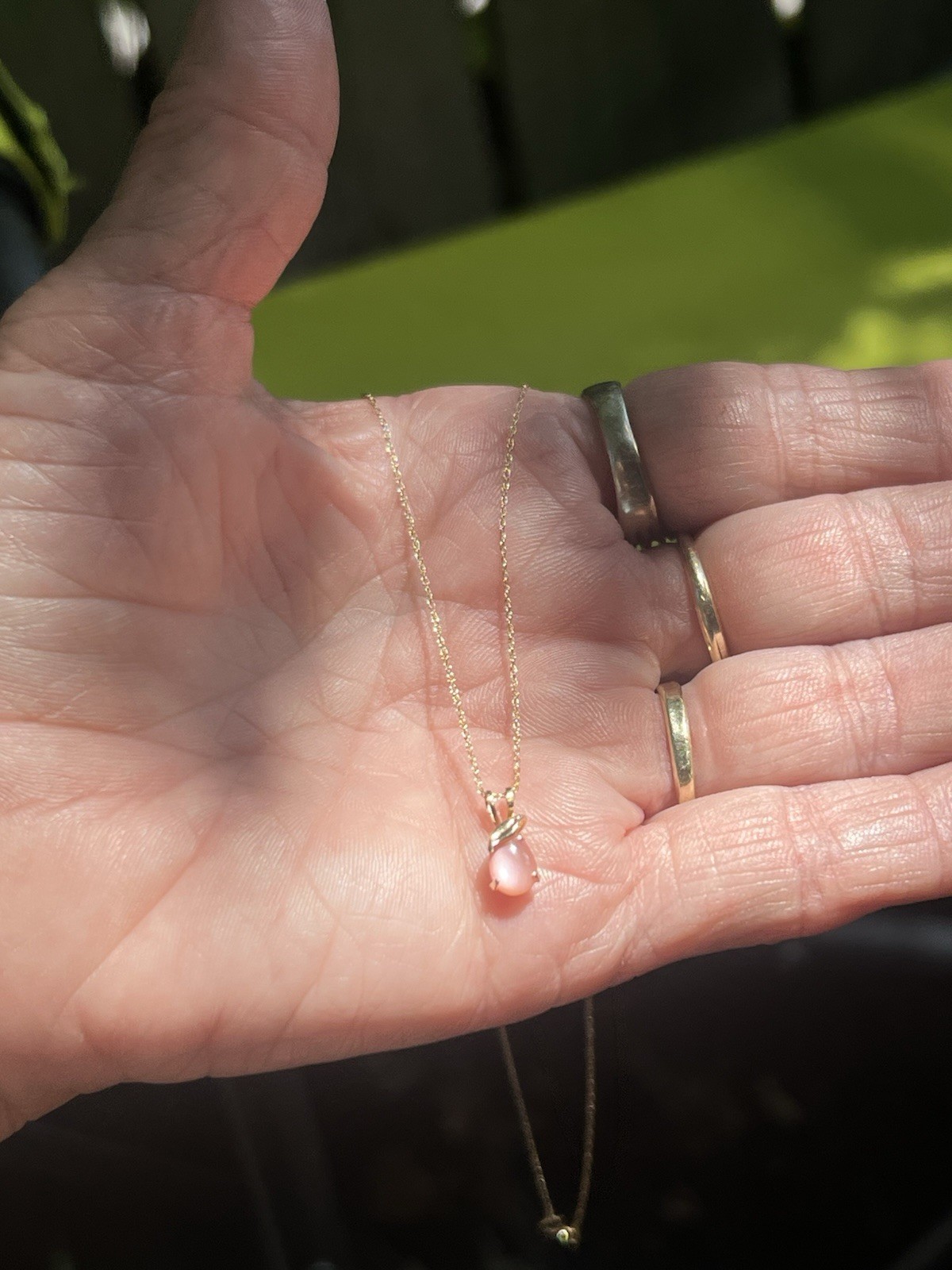 Pear shaped rose quartz set in 14k gold pendant with 14k gold 1.5 mm twist chain