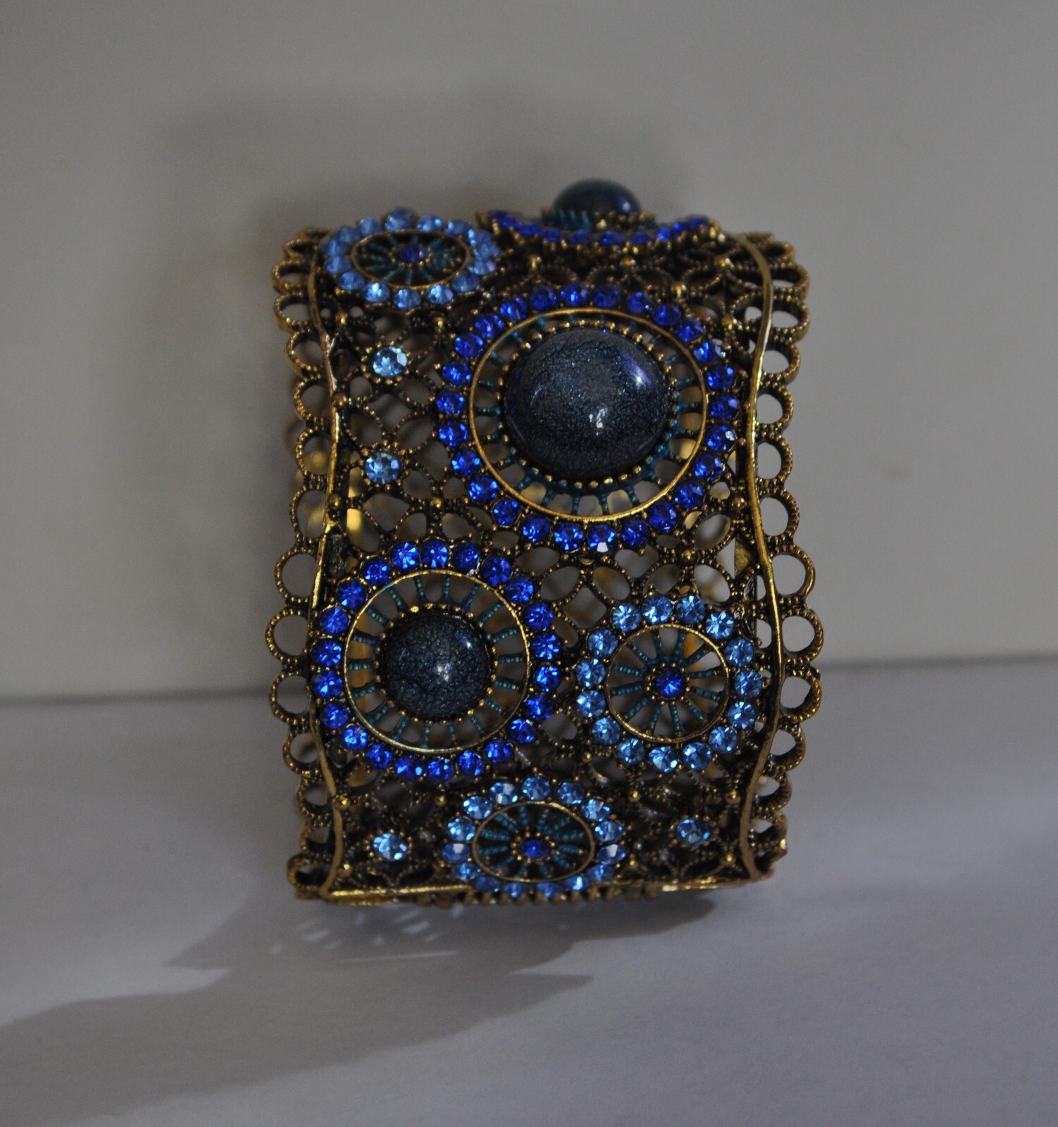 KIRKS FOLLY ROYAL BLUE CRYSTAL CUFF BRACELET IN ANTIQUE GOLD TONE