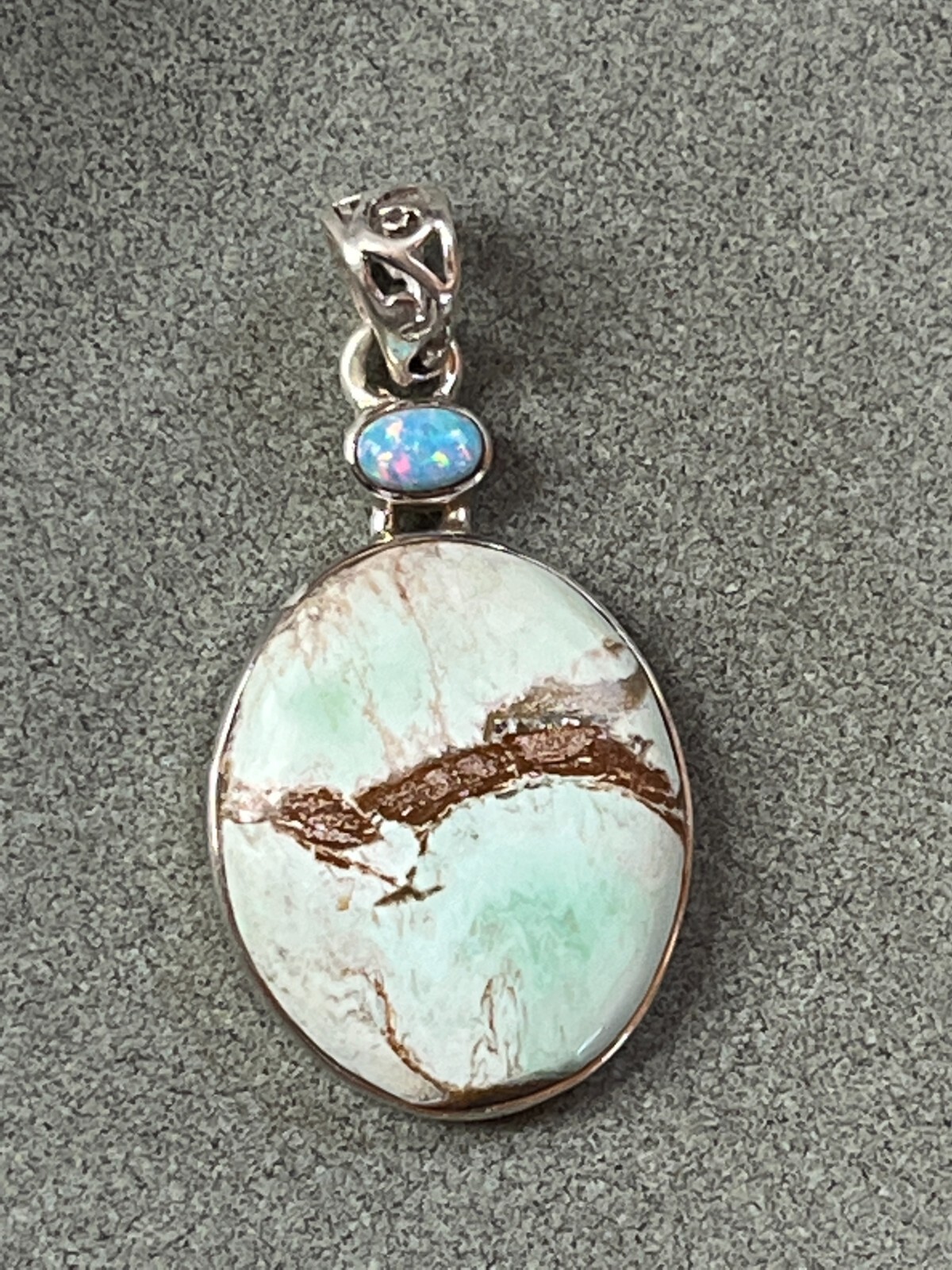 Small Lab Created Opal & Light Blue w Brown Veins Oval Stone in 925 Silver Frame