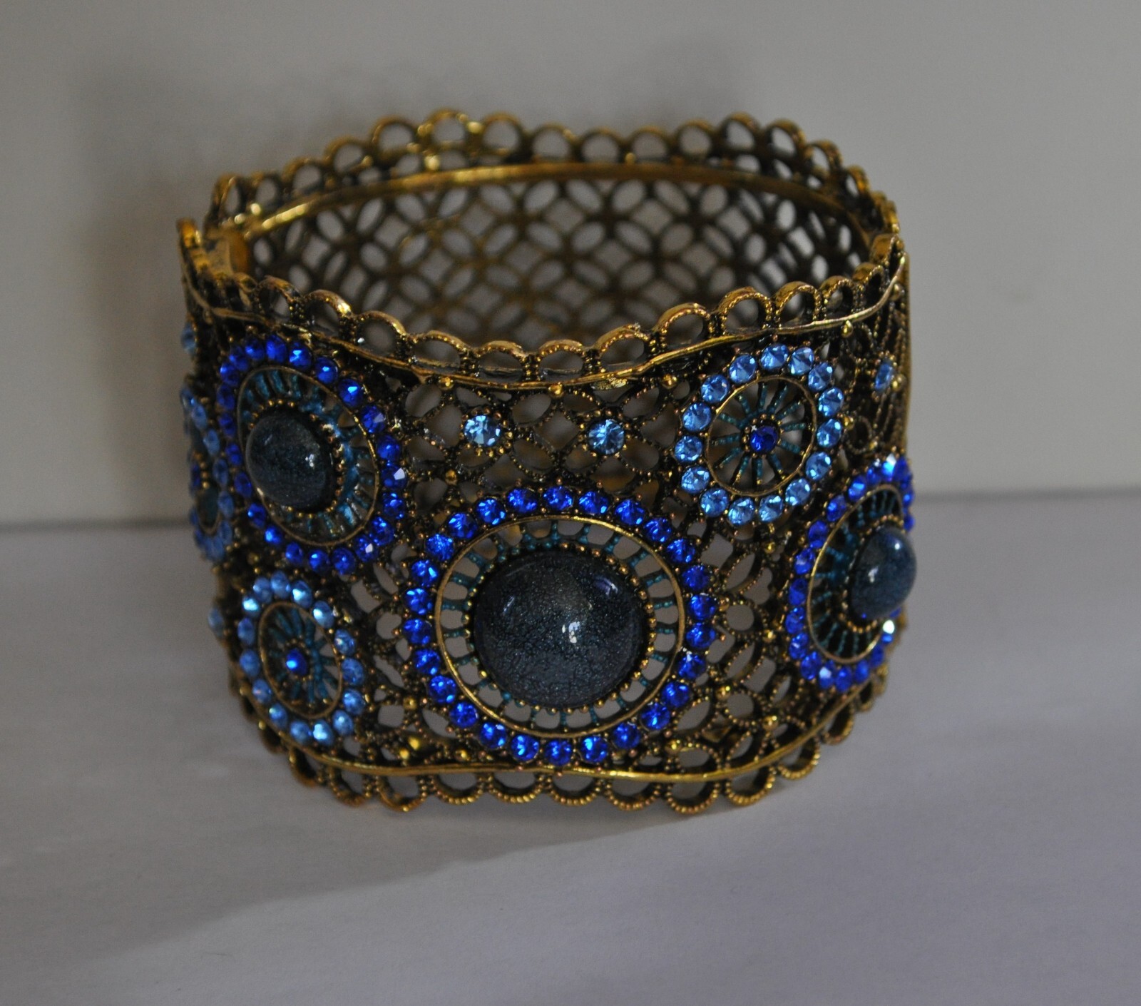 KIRKS FOLLY ROYAL BLUE CRYSTAL CUFF BRACELET IN ANTIQUE GOLD TONE