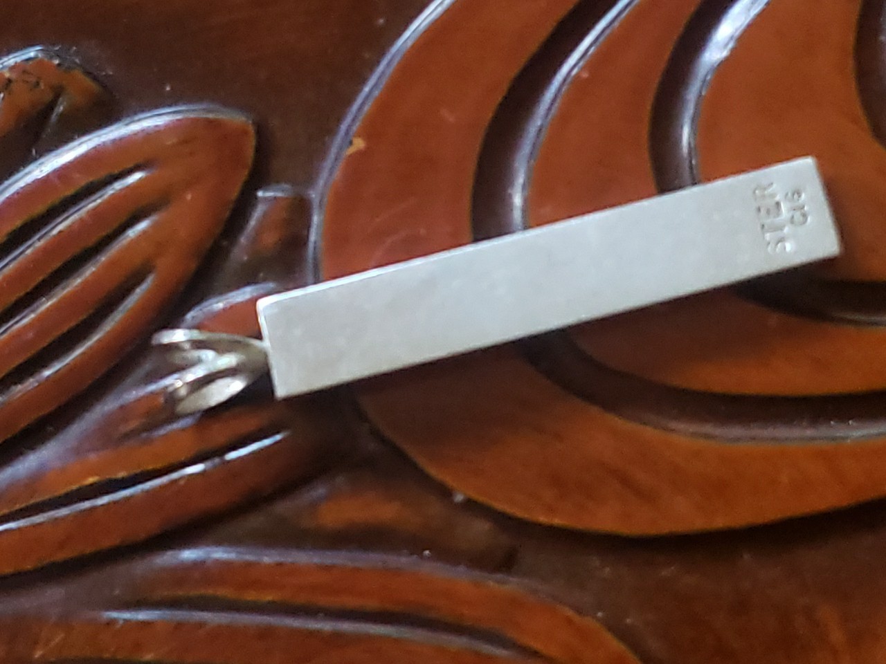 Vintage Silver Hawaiian Heirloom Kuuipo Gray Enamel Pendant Satin Sand Backgroun