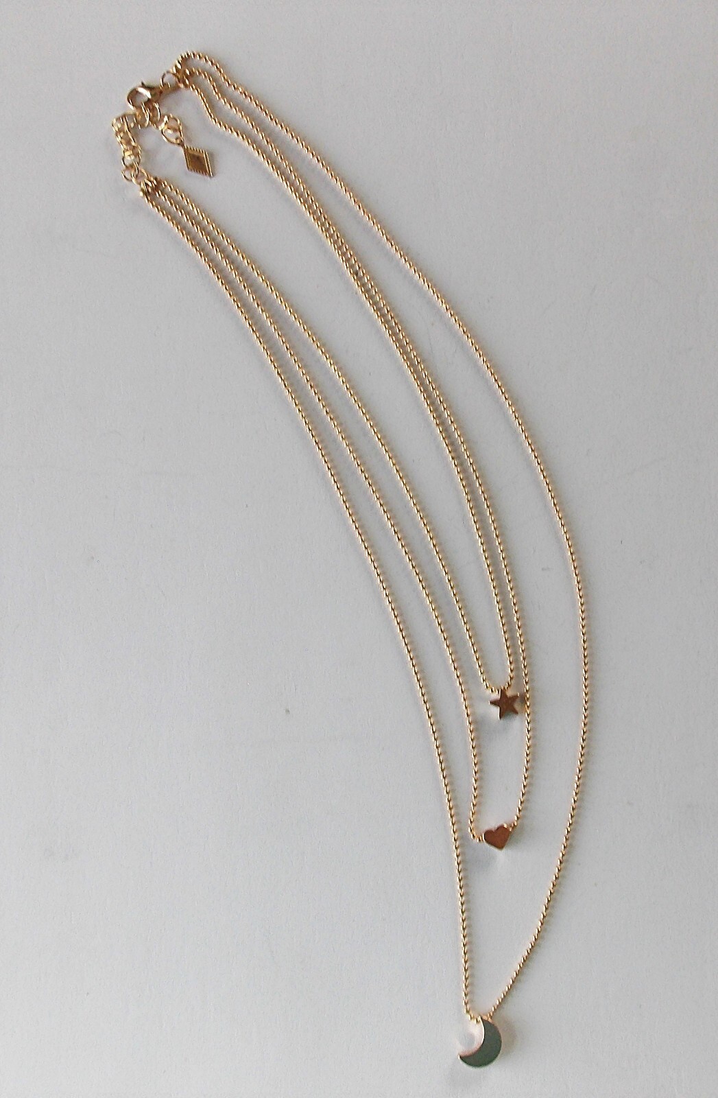 MULTI-LAYER GOLDTONE ADJ. 3 STRAND STAR, HEART, & CRESCENT MOON PENDANT NECKLACE