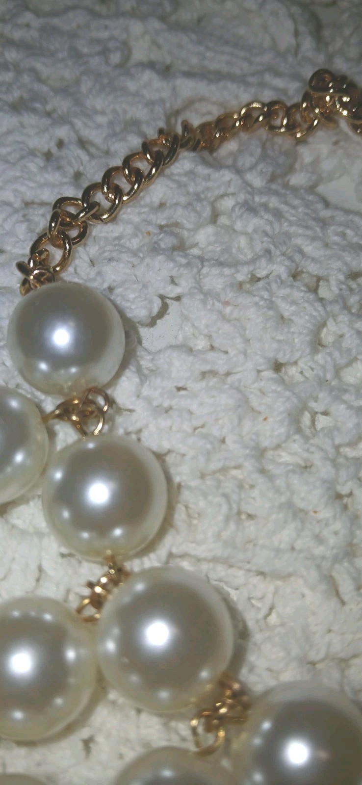 This gold-tone faux pearl cluster bib statement necklace features layered…