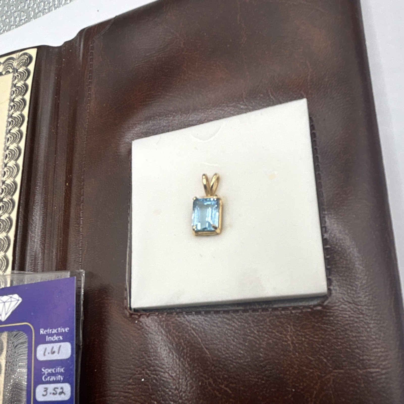 Genuine blue topaz emerald cut stone pendant, 14k gold frame