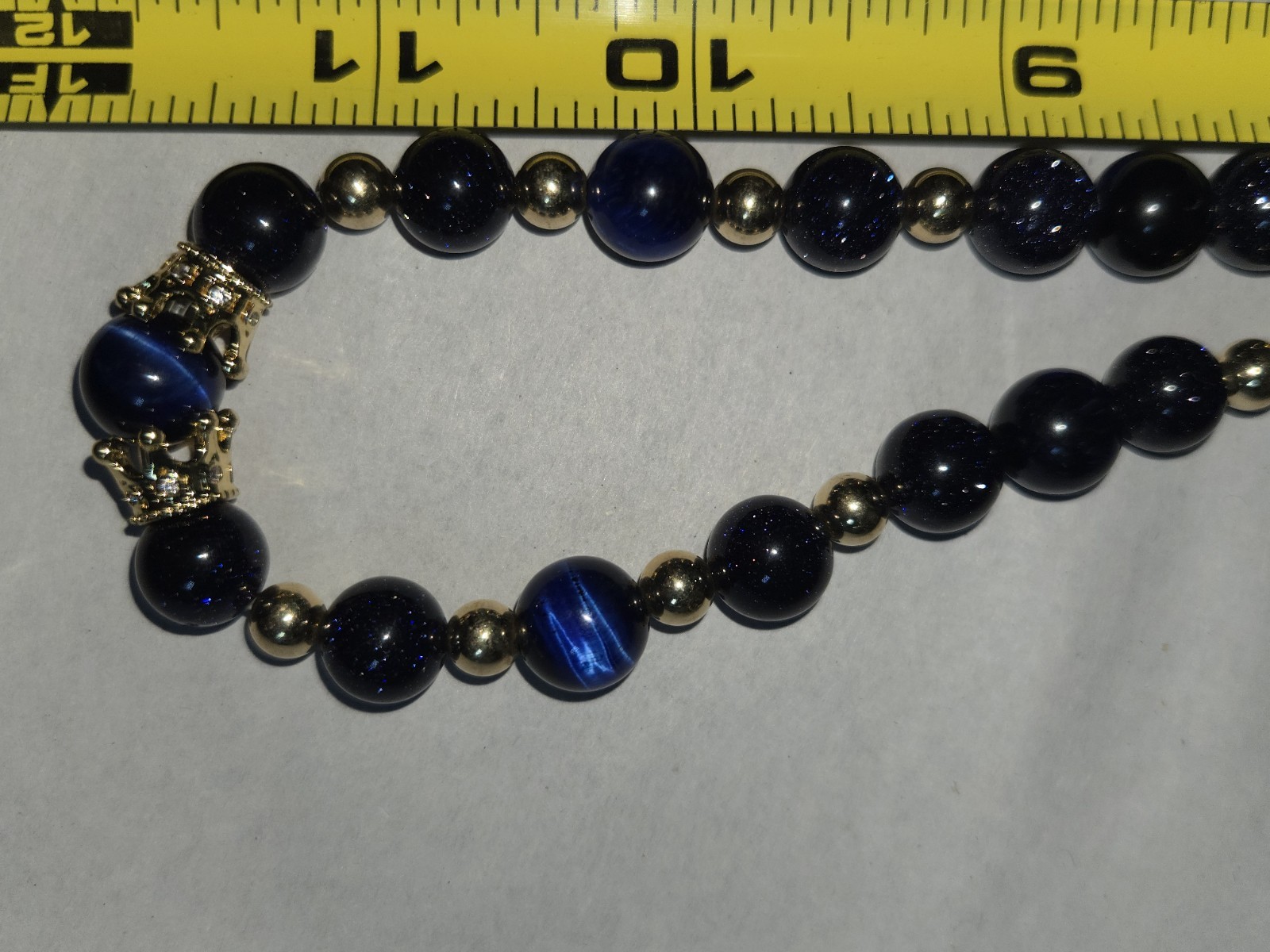 necklace round sparkly blue glass beads accented with small golden Spacer Beads