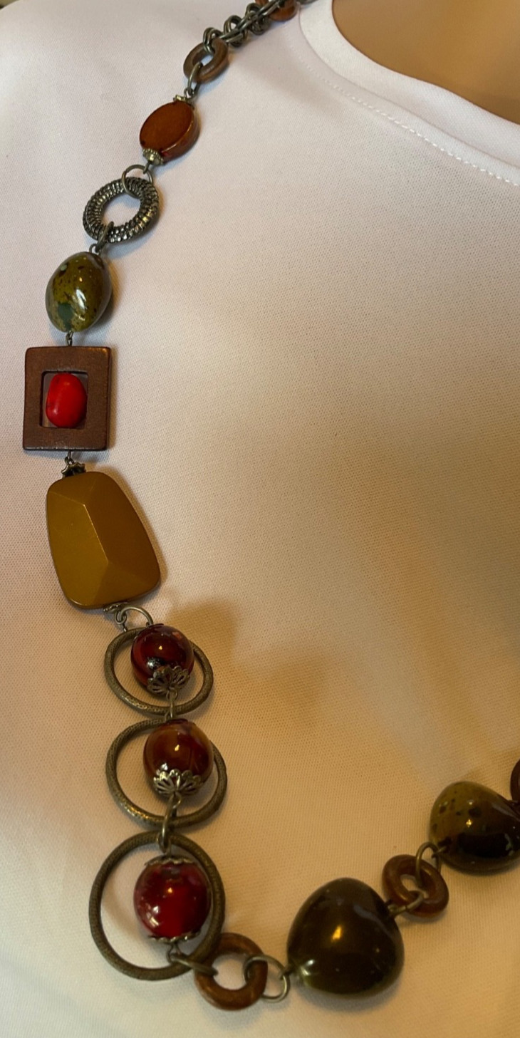 chicos 37” necklace featuring red, green and brown beads with geometric rings