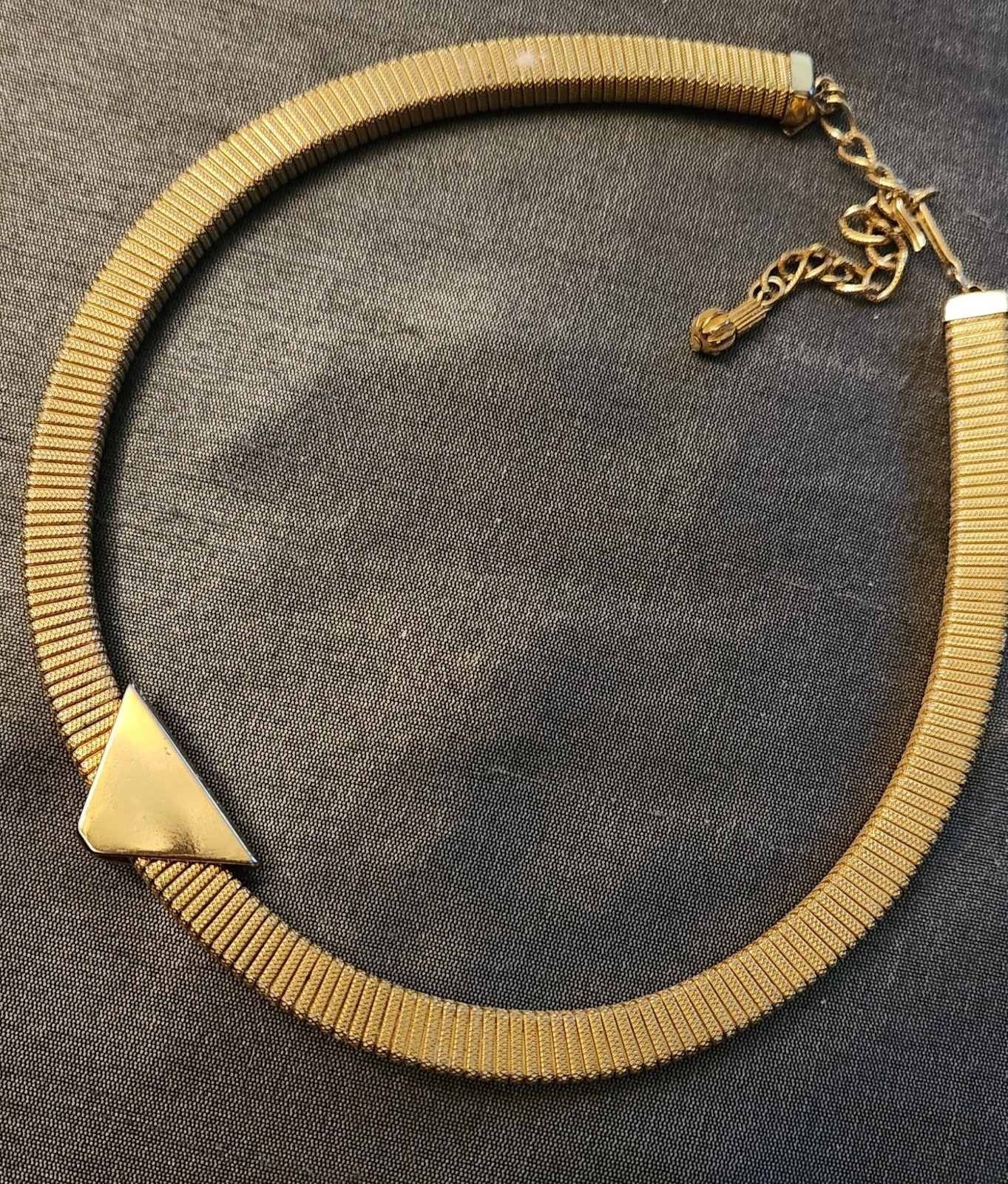 Goldtone chocker necklace, stretchy with triangular slide pendant