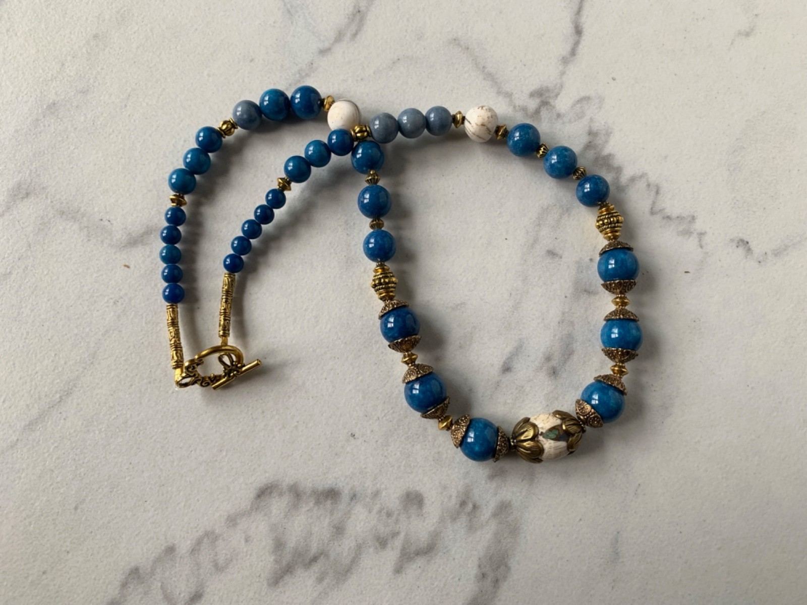 Conch Focal Bead in brass, Blue Howlite beads, Two Conch beads, 20″ Necklace 48