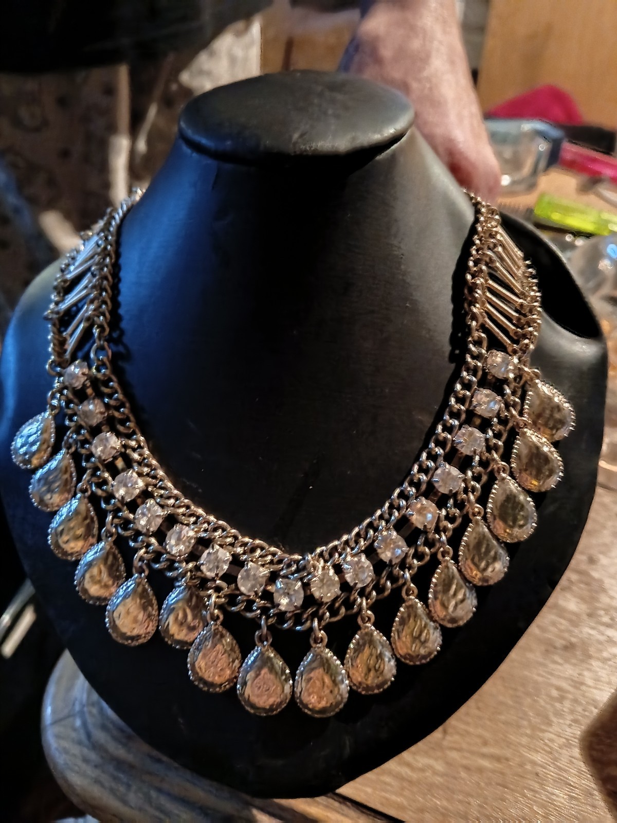 silver-toned bib choker features dangling teardrop rhinestones.