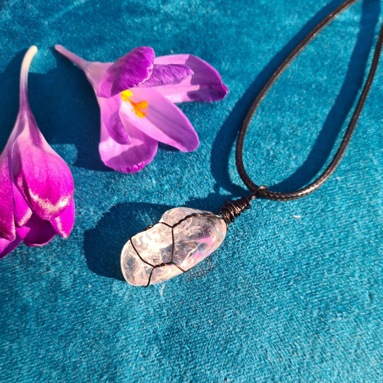Clear quartz wrapped pendant on a black cord