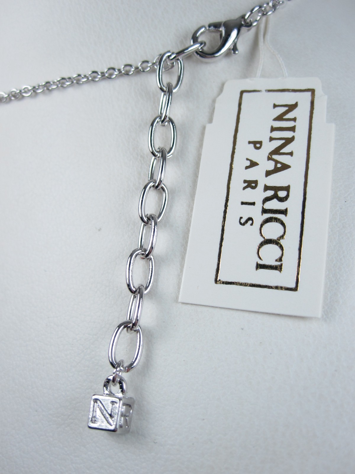 Nina Ricci Rhodium Plated Pendant with Swarovski Crystals – 16-18″ length 9379
