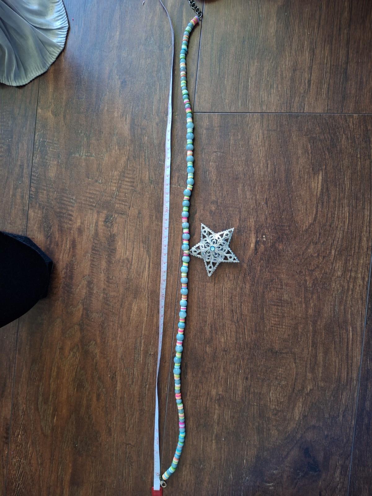 14 inch necklace with a star and multicolored and blue grey beads