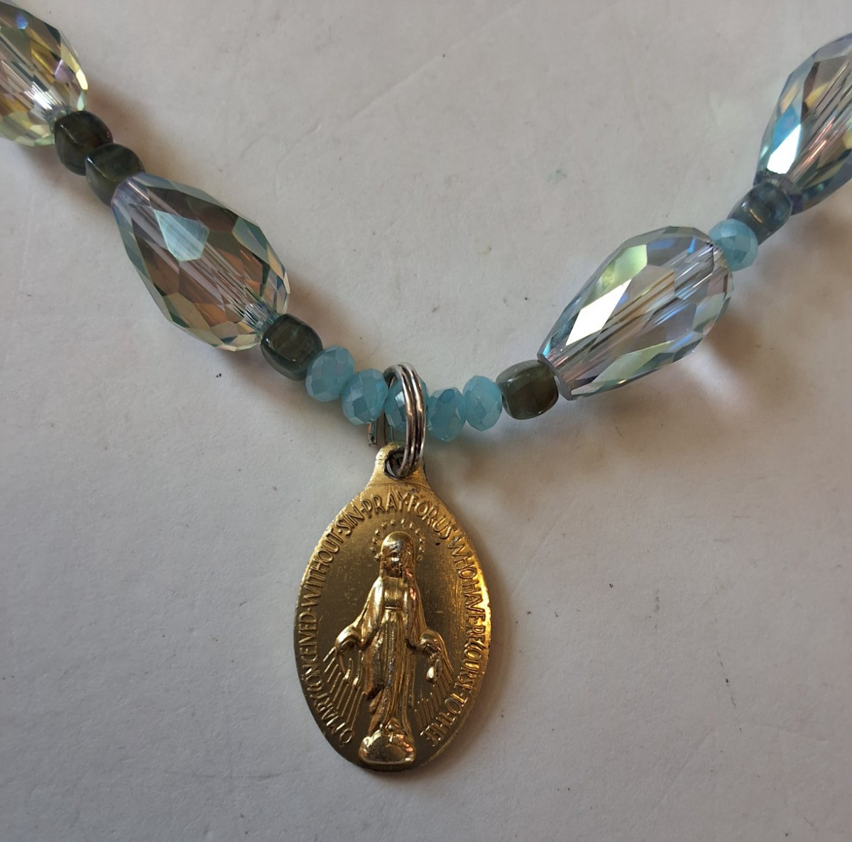 Iridescent Beaded Necklace With Gold Tone Miraculous Medal And Brooch