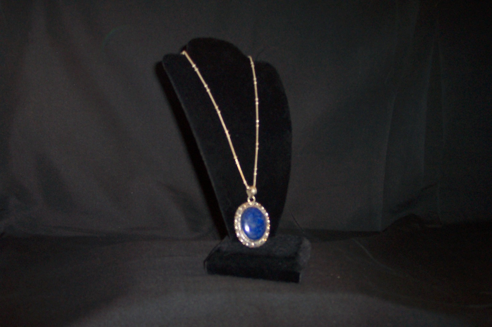 A lapis lazuli or saphire necklace with a metal necklace and metal edging