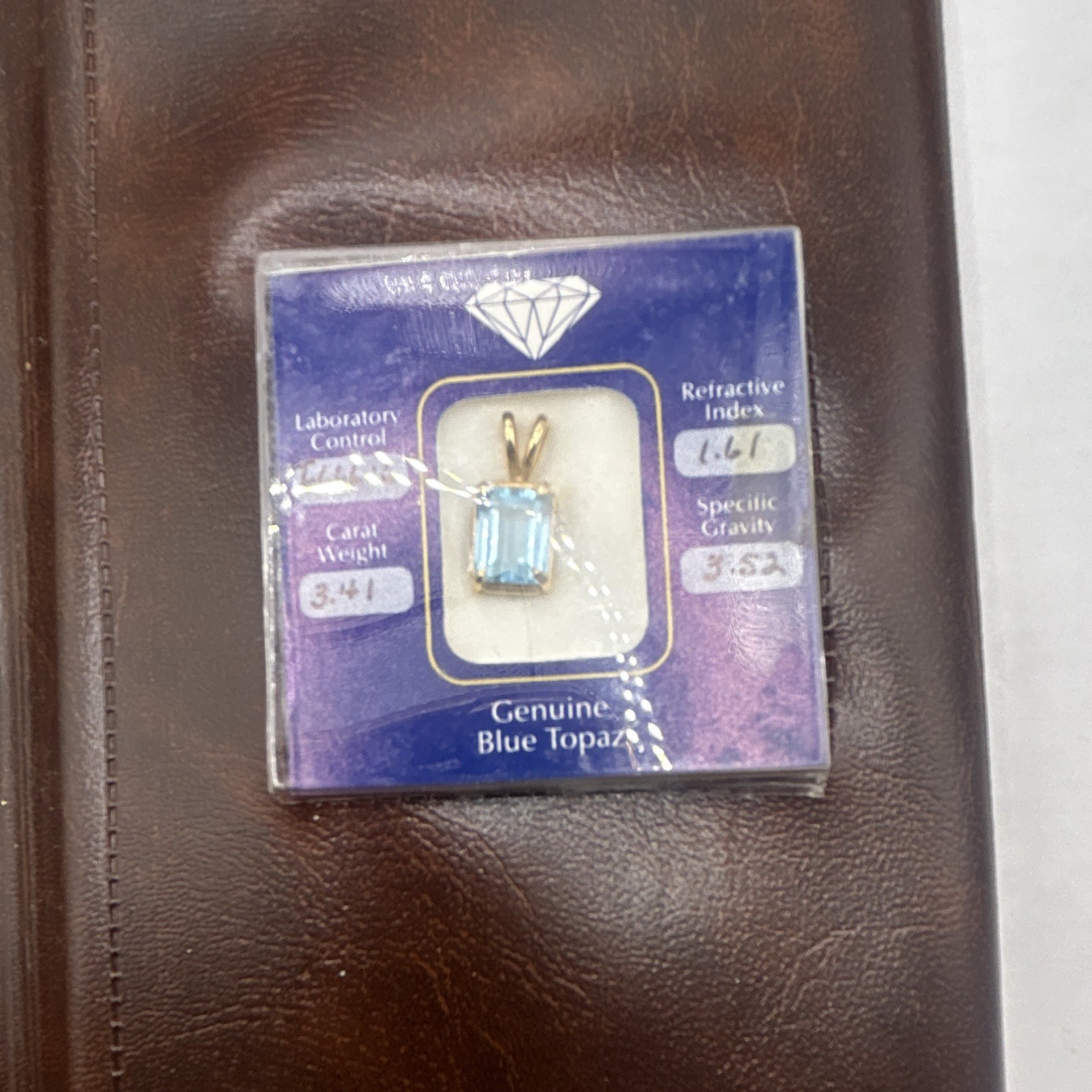 Genuine blue topaz emerald cut stone pendant, 14k gold frame