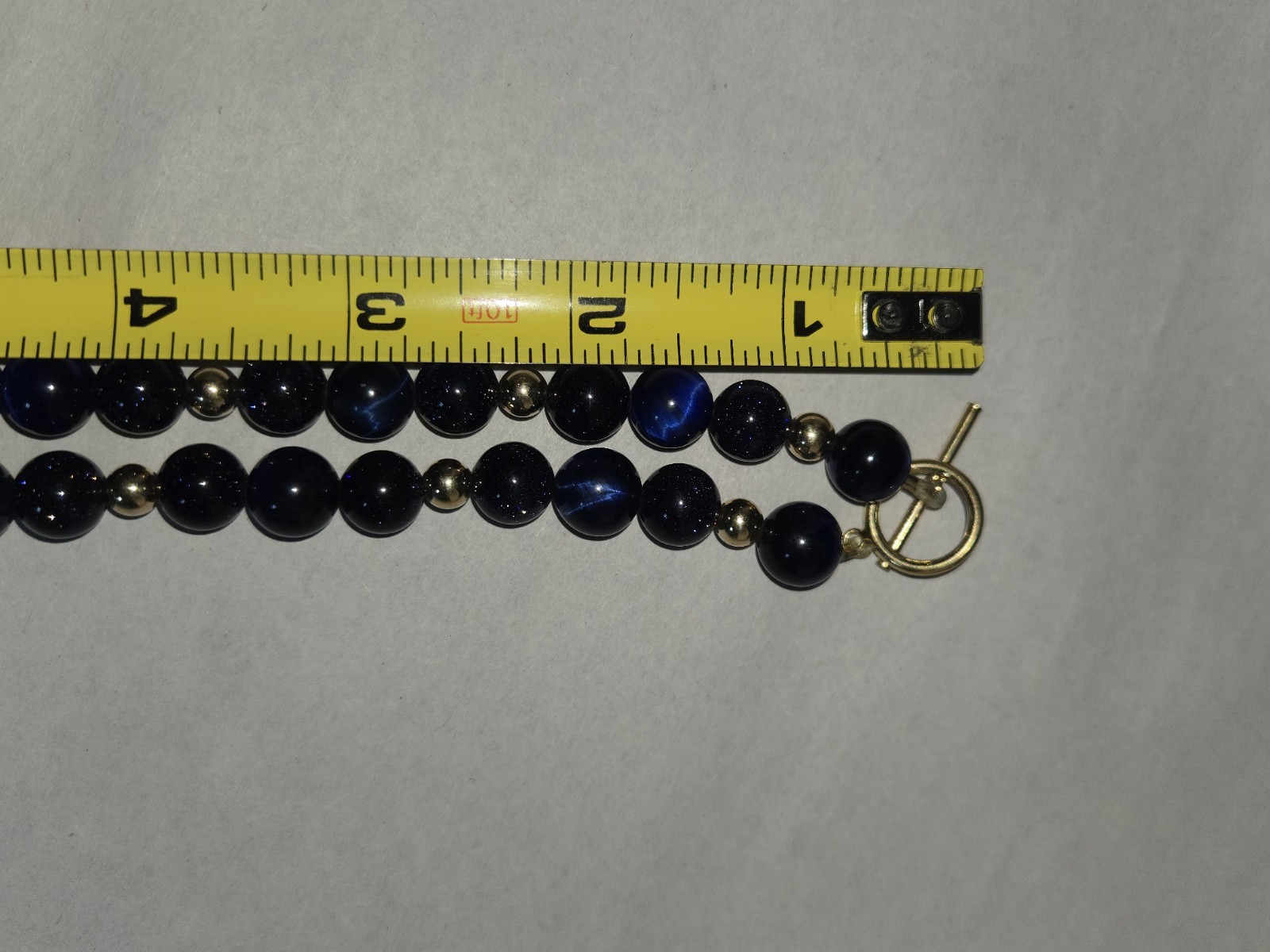 necklace round sparkly blue glass beads accented with small golden Spacer Beads