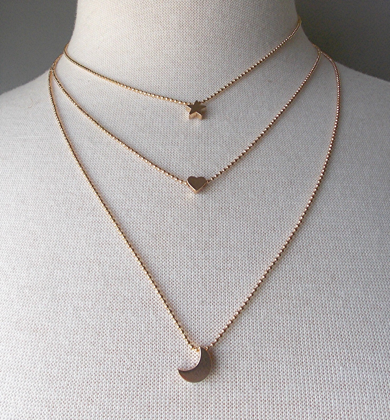 MULTI-LAYER GOLDTONE ADJ. 3 STRAND STAR, HEART, & CRESCENT MOON PENDANT NECKLACE