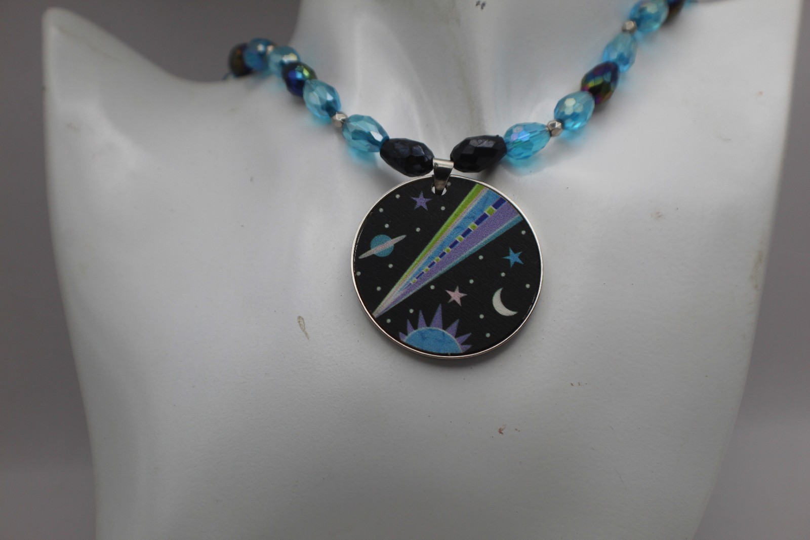 Space Pendant On A Beaded Necklace Black And Blue Beads