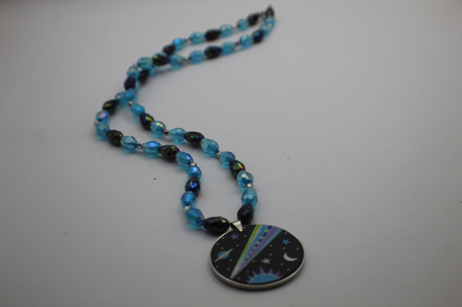 Space Pendant On A Beaded Necklace Black And Blue Beads