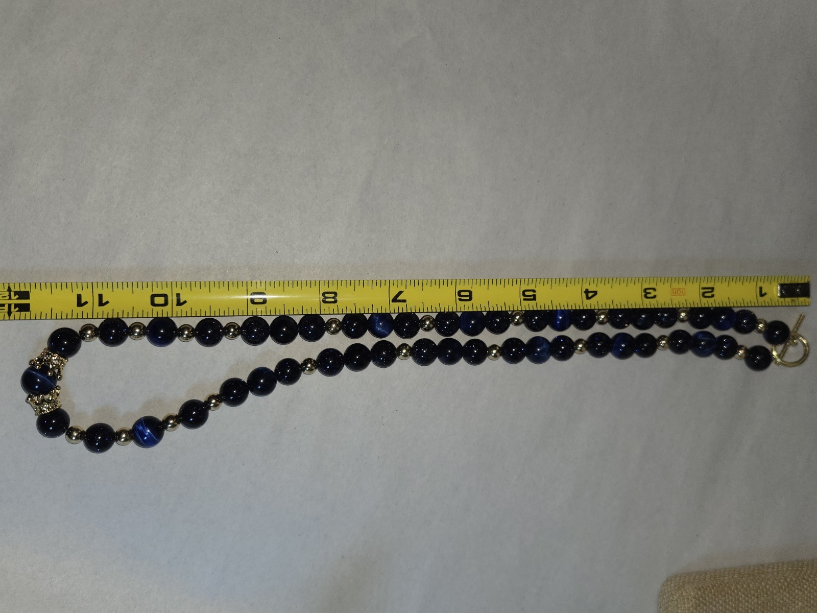 necklace round sparkly blue glass beads accented with small golden Spacer Beads