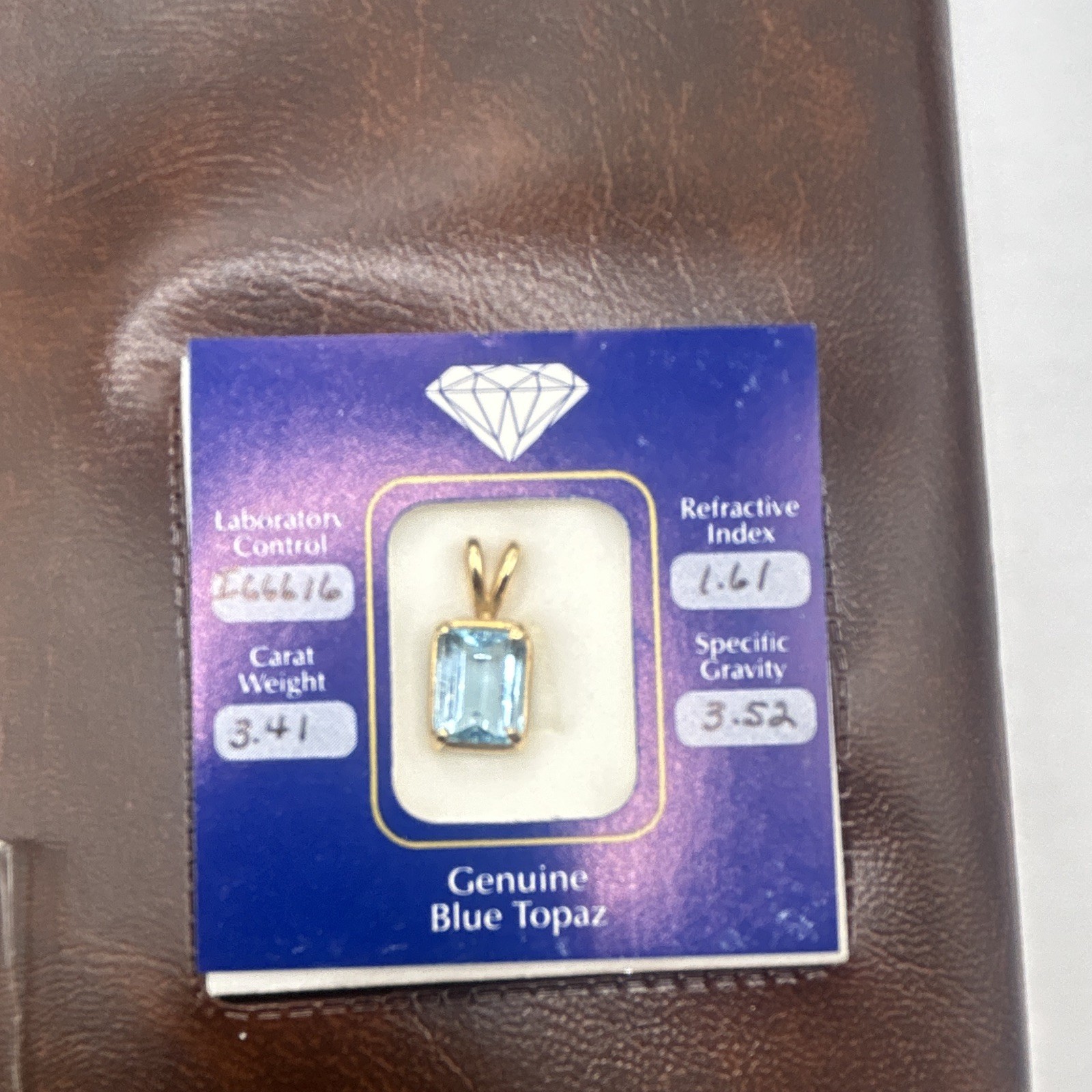 Genuine blue topaz emerald cut stone pendant, 14k gold frame