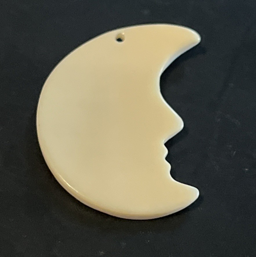 Carved Conch Shell Man In Crescent Moon Pendant