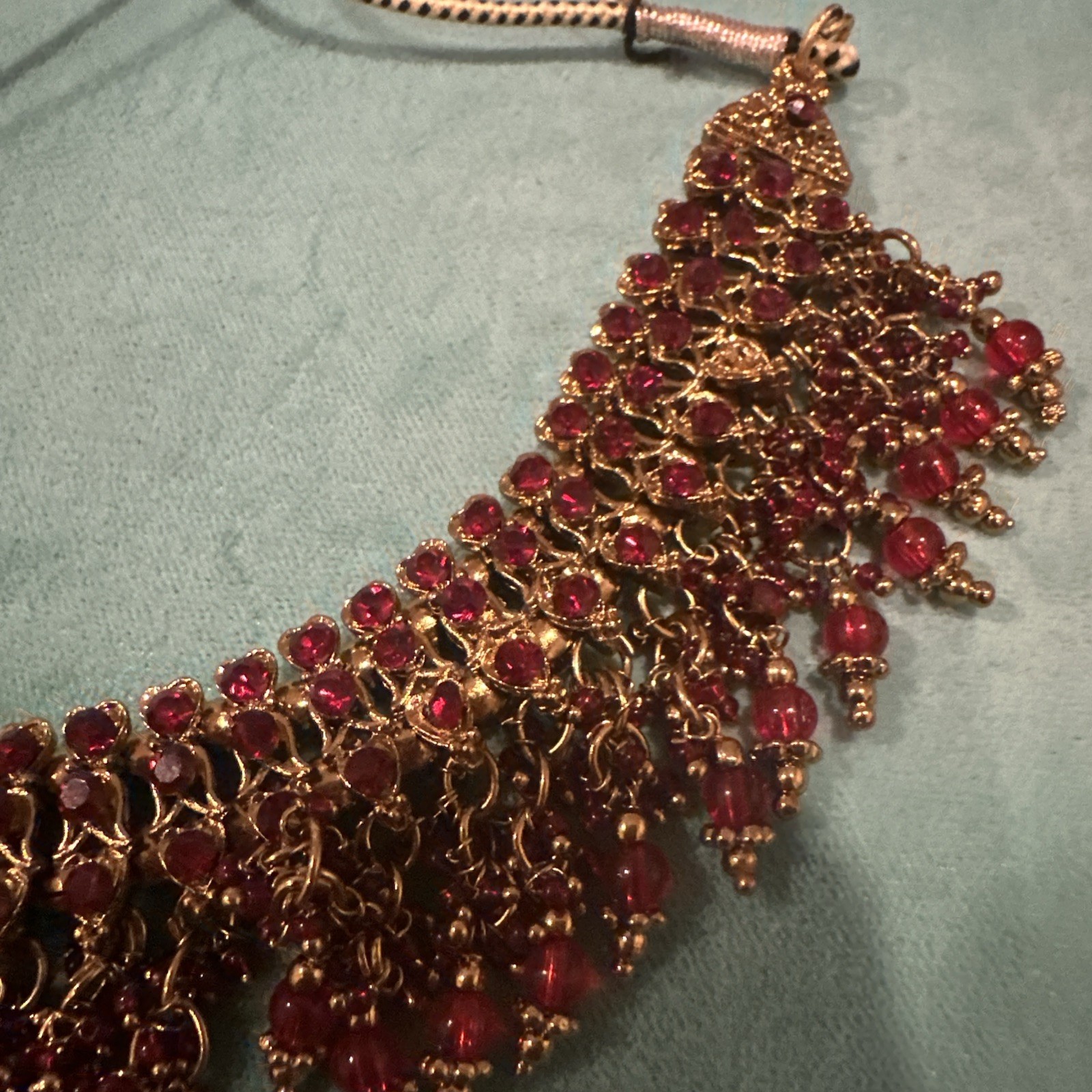 Fashion Jewelry Maroon Necklace With Jhumkas With Hair Attachment In Gold Tone