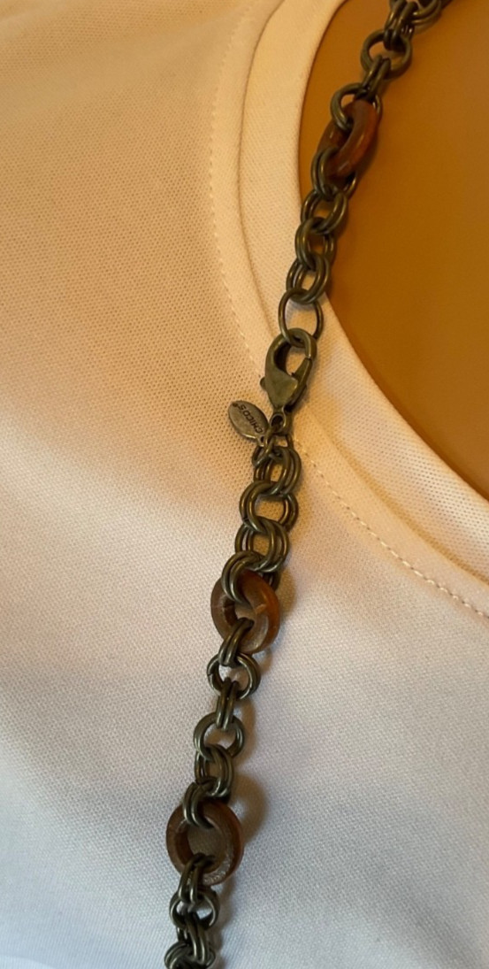 chicos 37” necklace featuring red, green and brown beads with geometric rings