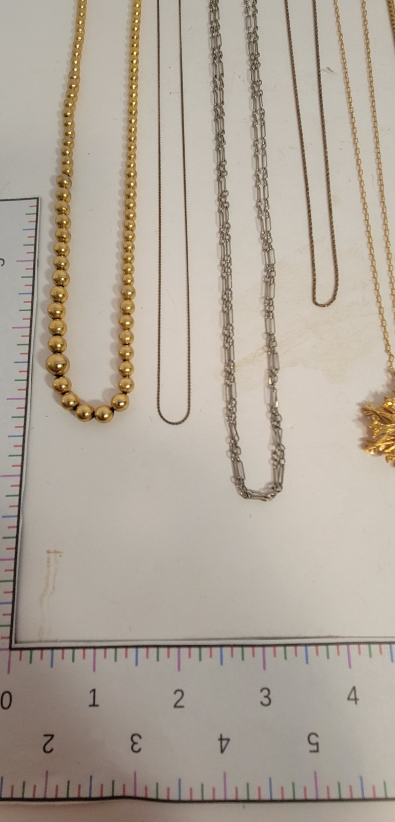 Lot of 11 metal chain necklaces, 6 with pendants. Various metals.
