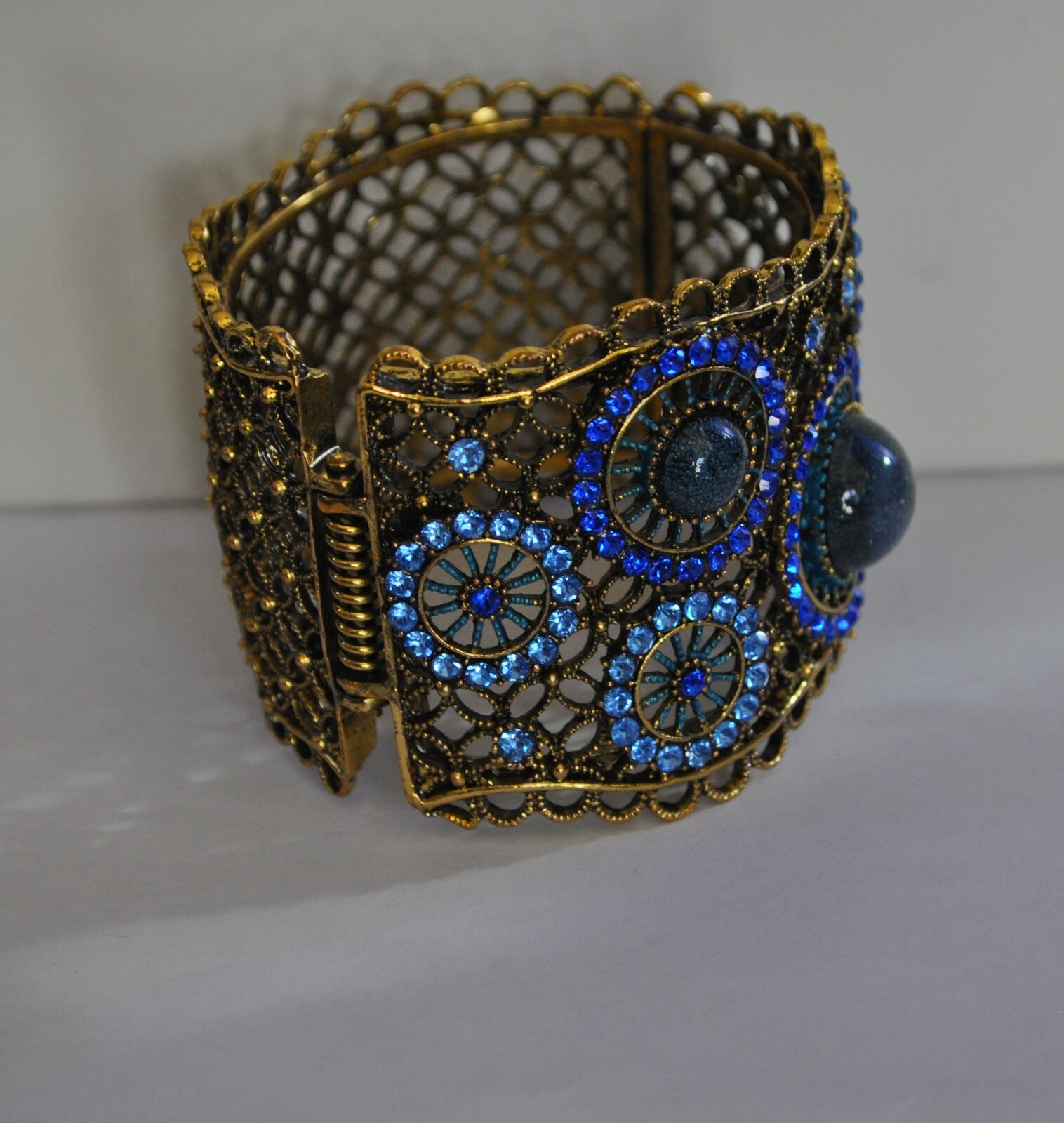 KIRKS FOLLY ROYAL BLUE CRYSTAL CUFF BRACELET IN ANTIQUE GOLD TONE