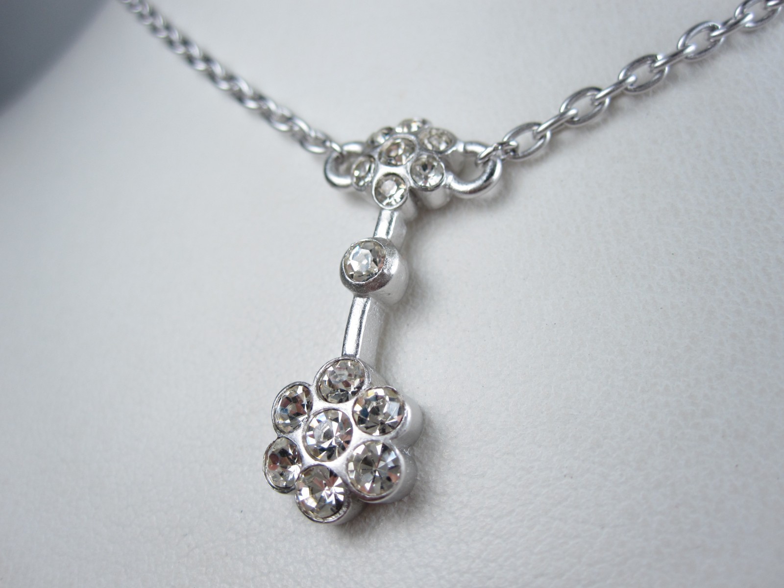 Nina Ricci Rhodium Plated Pendant with Swarovski Crystals – 16-18″ length 9380