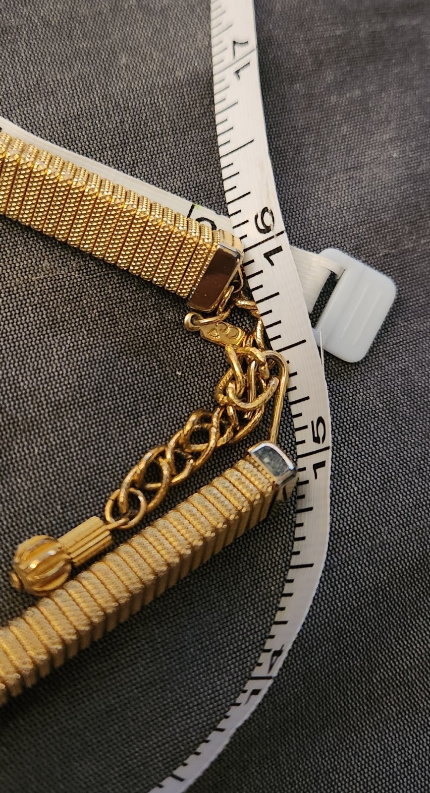 Goldtone chocker necklace, stretchy with triangular slide pendant