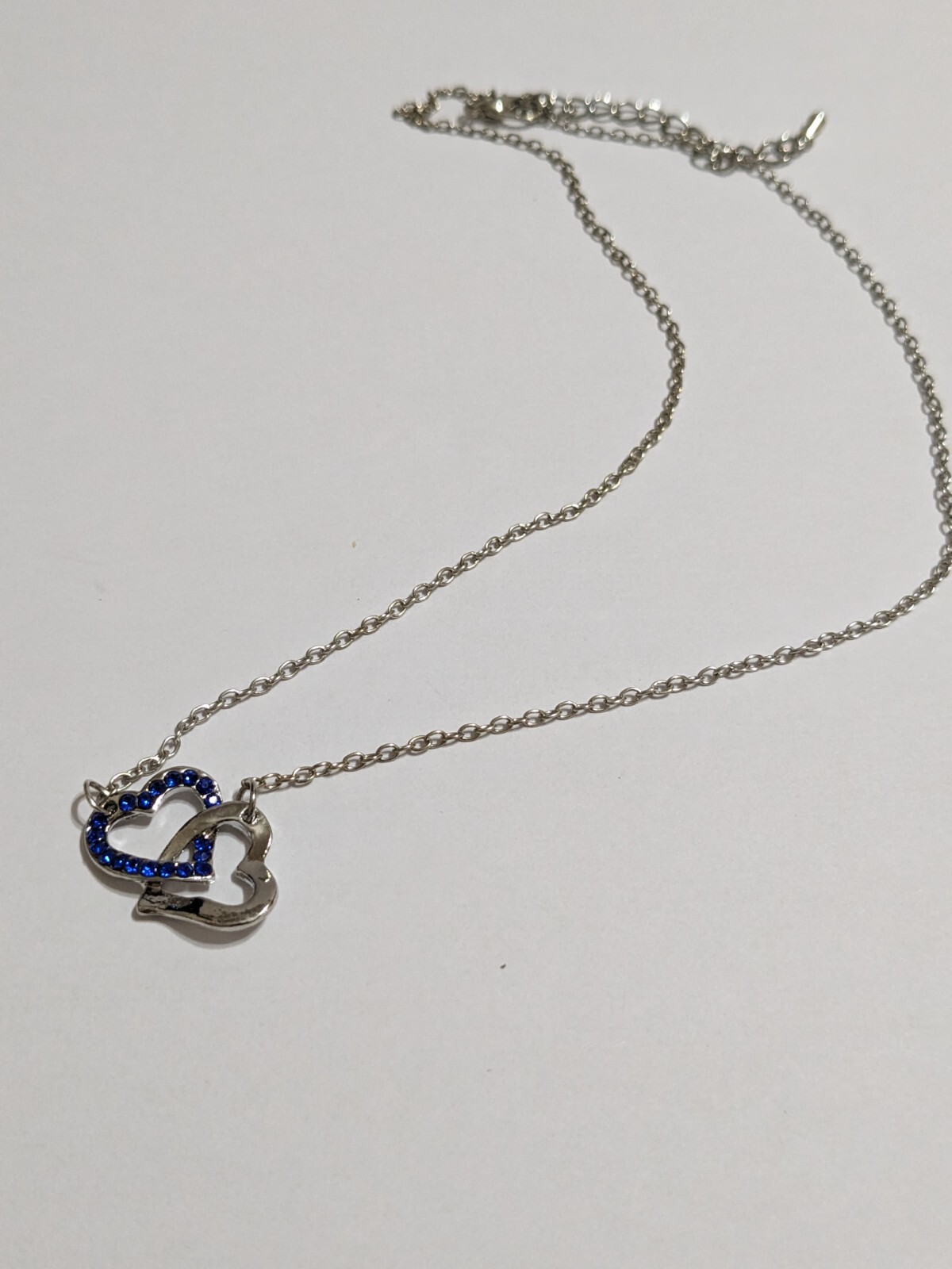 Interlinked Hearts Blue Rhinestones & Silver Tone Pendant Necklace. 16″. 2″ Ext.