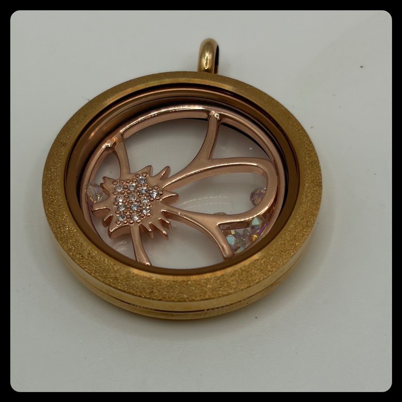 Origami Owl rose gold memory locket featuring a flower charm with crystal accent