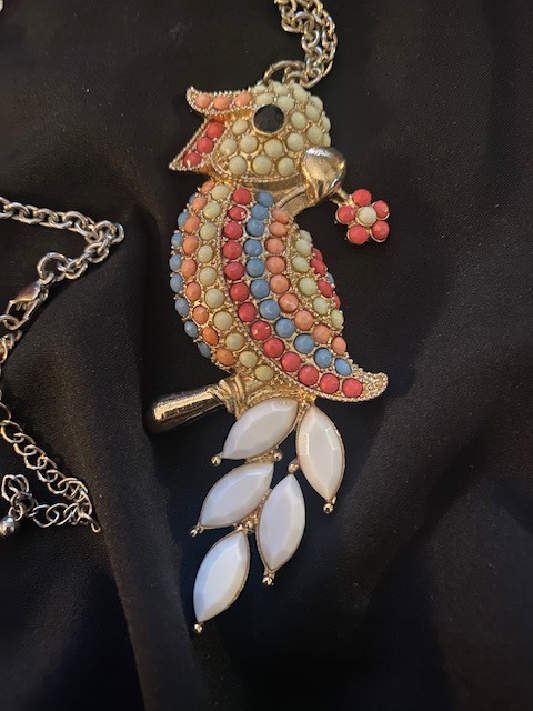 Gold-tone, multi-colored enamel and rhinestone parrot pendant necklace.