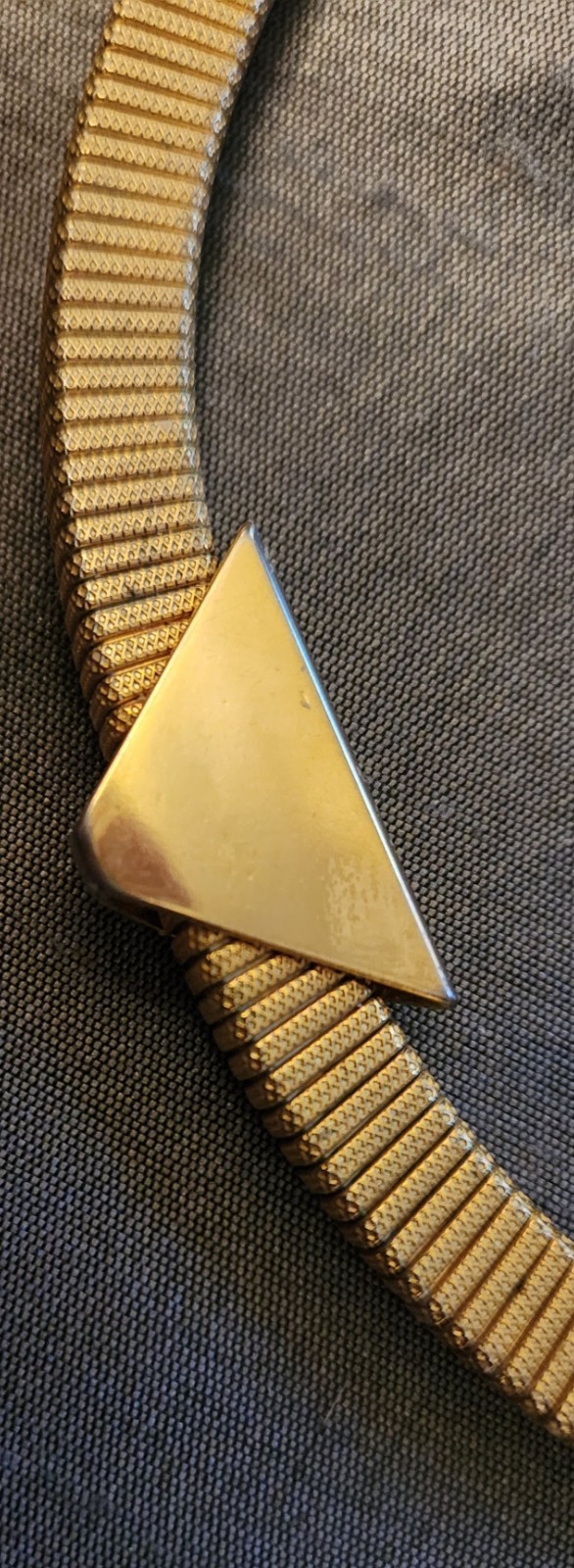 Goldtone chocker necklace, stretchy with triangular slide pendant