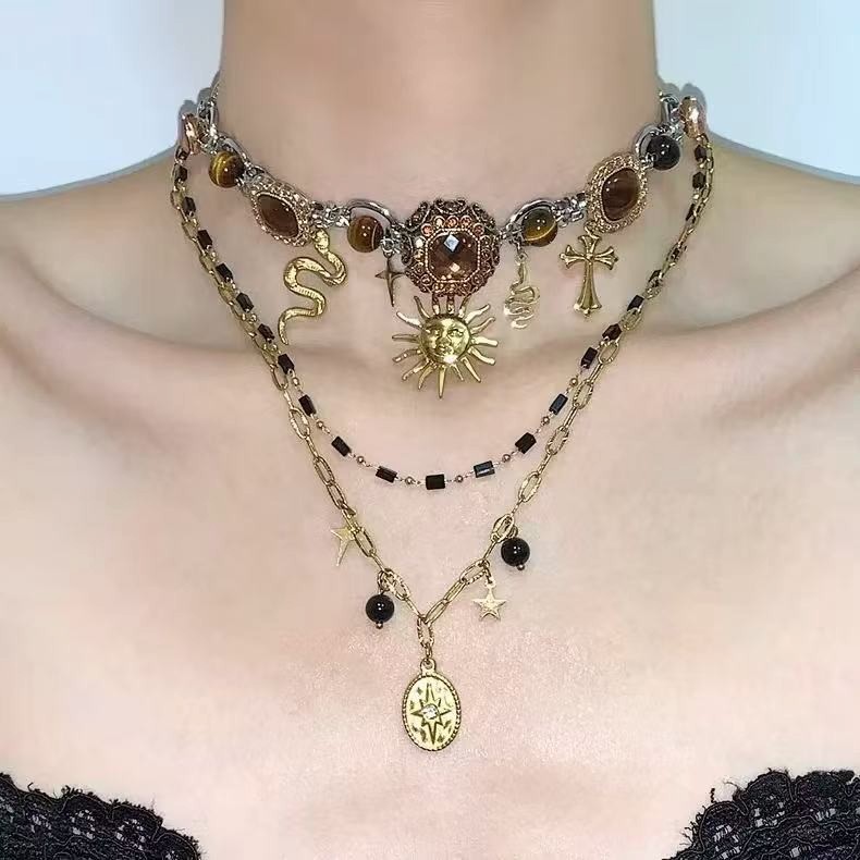 Gothic-style layered choker necklace featuring a sun and snake tiger’s eye penda