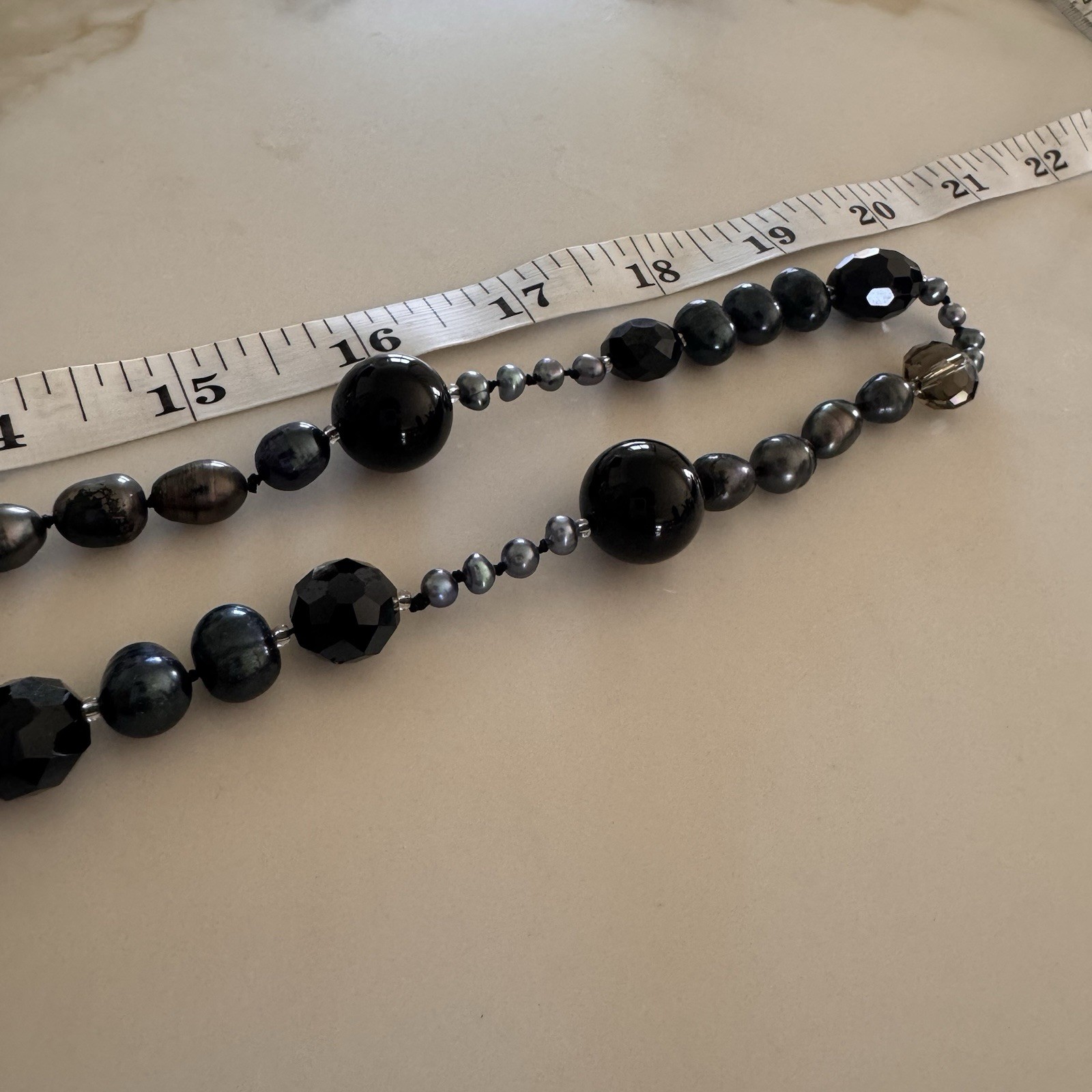 beautiful peacock pearl necklace with faceted gray and black beads