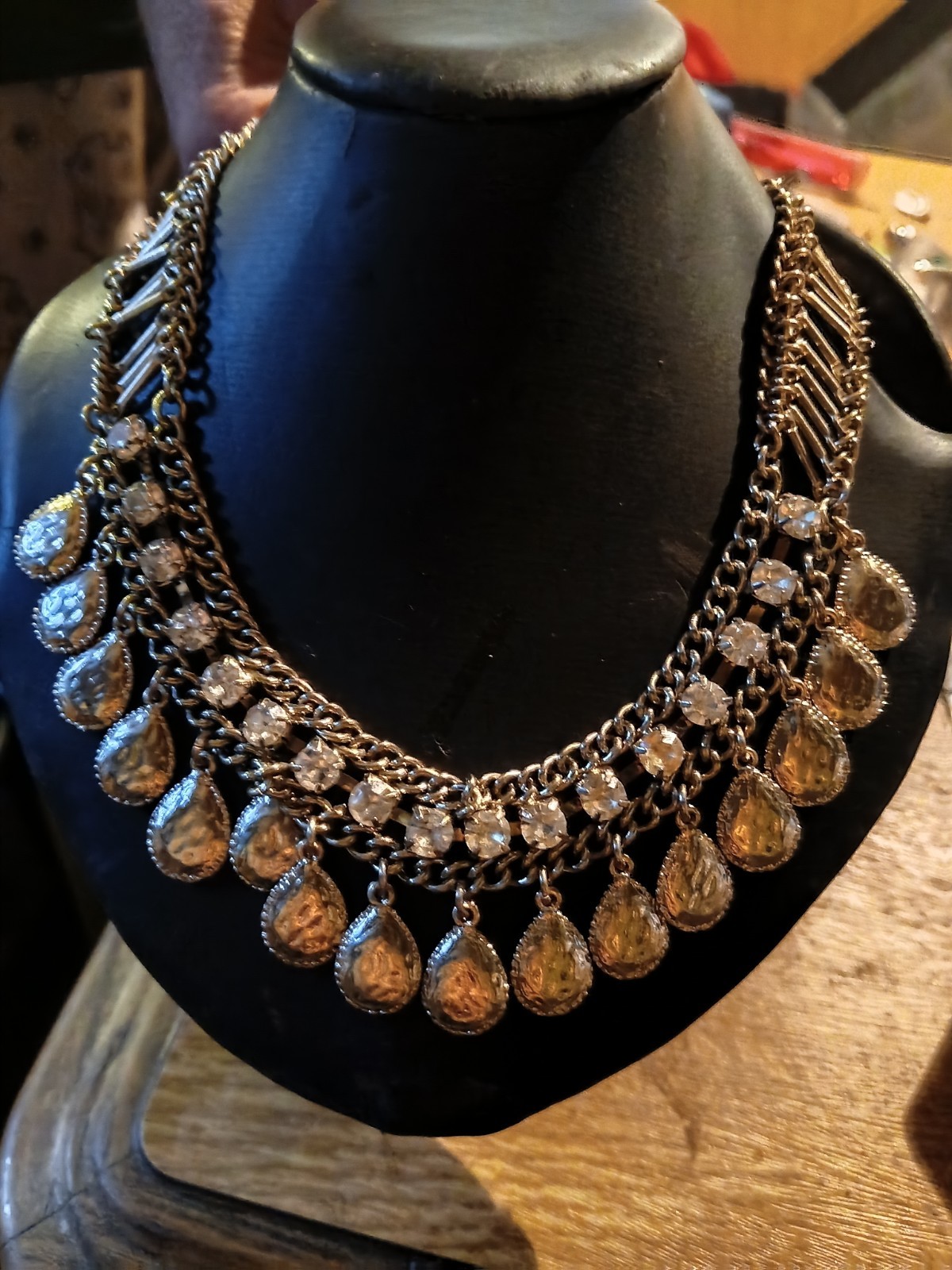 silver-toned bib choker features dangling teardrop rhinestones.