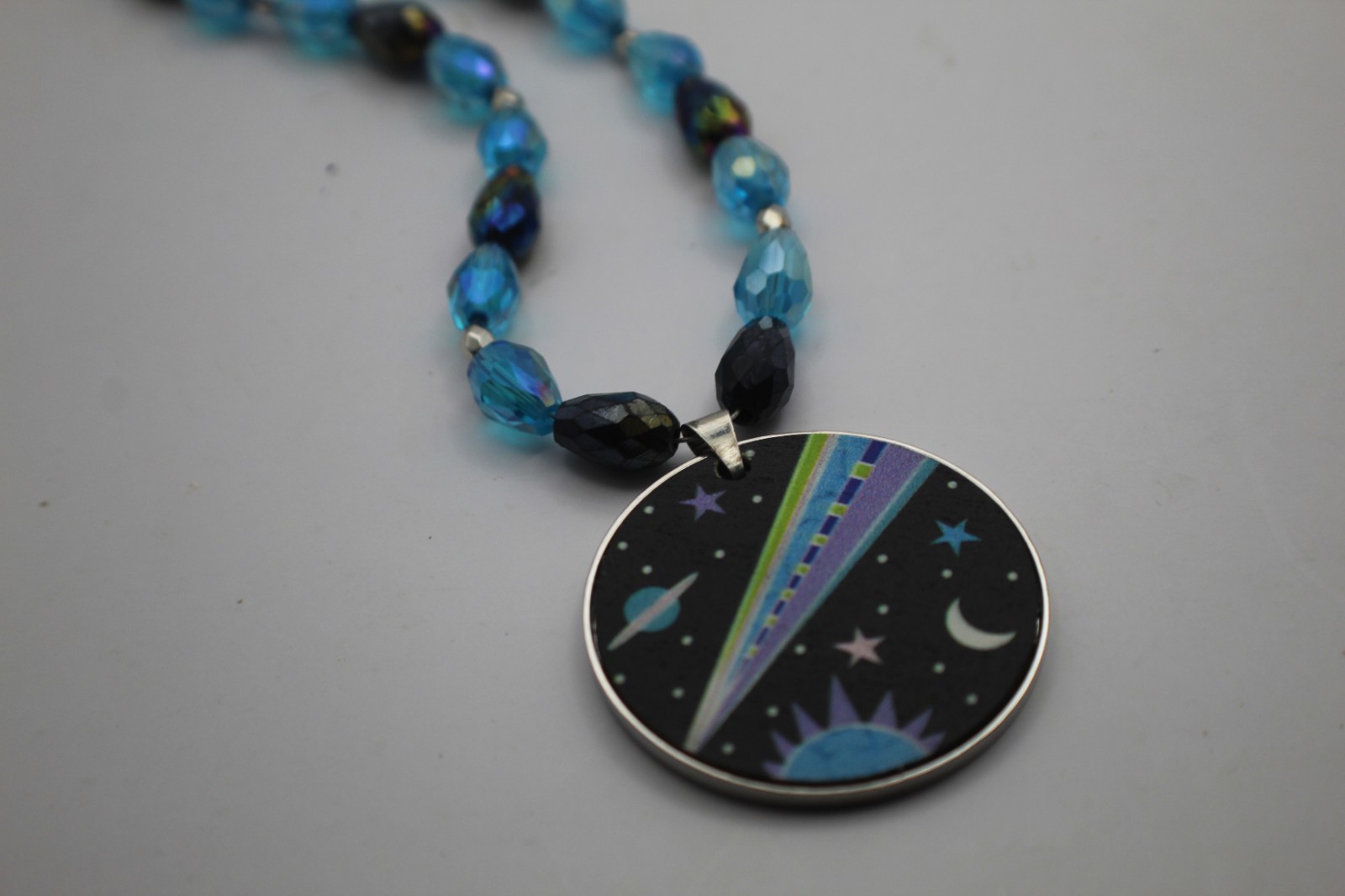 Space Pendant On A Beaded Necklace Black And Blue Beads